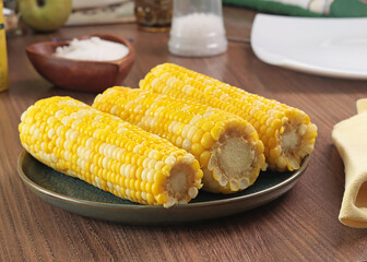 Sweet cooked corn fruit on plate. Food and cooking. Health and nutrition. Background for design. 