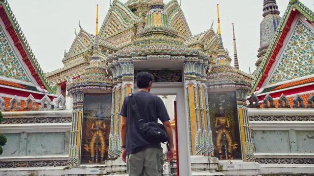 asia travel concept with photographer man see old architecture and pagoda at thailand temple