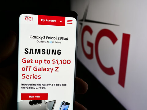 Stuttgart, Germany - 07-31-2024: Person holding cellphone with webpage of US telecommunications company GCI Communication Corp. in front of logo. Focus on center of phone display.