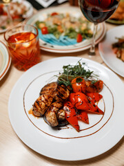 delicious salad with juicy mushrooms, grilled fresh vegetables, and fragrant herbs, drizzled with sauce on a beautiful plate in a cozy nice restaurant