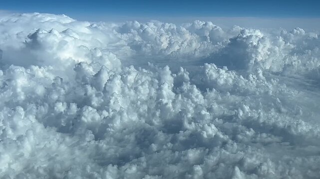 POV flying above storm clouds in a blue sky. Immersive and exclusive pilot perspective flyingb atb cruise level FL300. 4K 60FPS