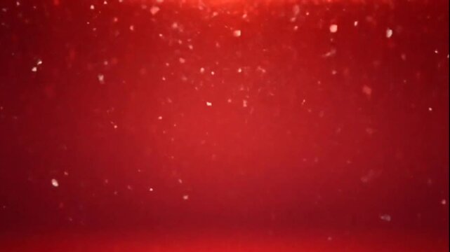 Falling red glitter on a red background