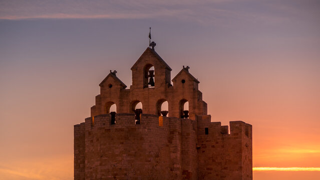 bell tower of saintes maries de la mer at sunset - Camargue - France