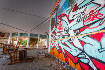 Graffiti on the wall of a vandalized room of an abandoned hotel. Abandoned hotel. Hotel Neptuno....