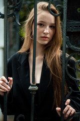 young beautiful woman posing on the street formal modern clothes. beautiful fashionable girl posing in the street