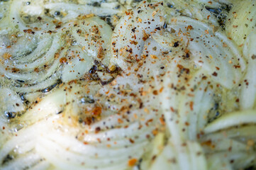 fried onion background, in a pan with seasonings and spices, cooking, selective focus