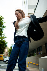 young beautiful woman posing on the street formal modern clothes. beautiful fashionable girl posing in the street