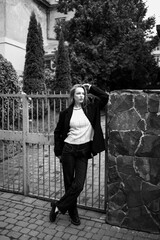 young beautiful woman posing on the street formal modern clothes. beautiful fashionable girl posing in the street