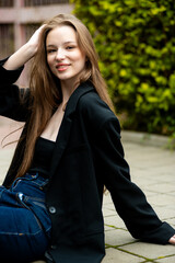 young beautiful woman posing on the street formal modern clothes. beautiful fashionable girl posing in the street