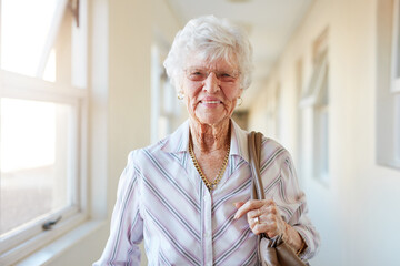 Senior woman, portrait and smile in retirement home with glasses for peace, health and positive...