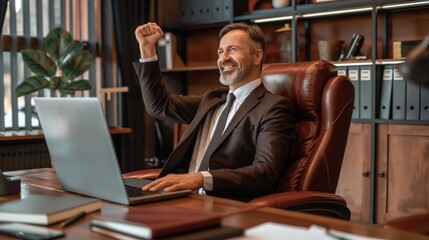 A business professional expresses joy and satisfaction while sitting at his desk in a modern office, celebrating a recent achievement during a remote work session