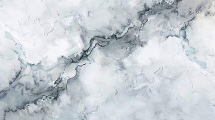 A close-up view of white and grey marble with natural veins creating a swirling, abstract pattern.