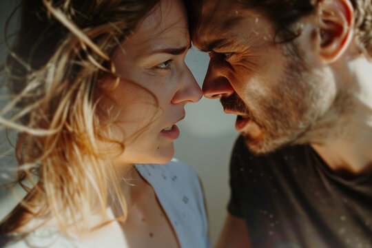Intense close-up of a couple facing each other with strong emotions and strained expressions. Concepts of relationship conflict, emotional tension, and personal struggles.
