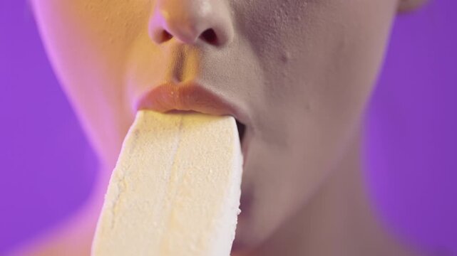 Woman eating ice cream seductively, close up mouth portrait
