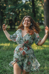 Fototapeta premium Joyful Woman Dancing Outdoors with Headphones