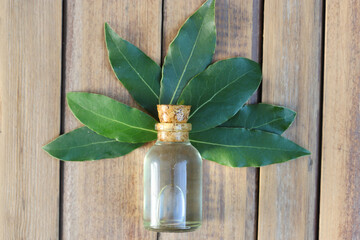 daphne essential oil in bottles on wooden table