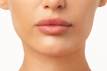 Lip filler injections and augmentation. Young woman with perfect lips with hyaluronic acid over...