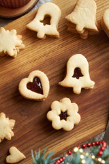 Fototapeta premium Linzer Christmas cookies filled with marmalade on a wooden table, top view