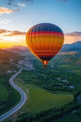 Obraz premium Hot Air Balloon Soaring Over Lush Green Valley at Sunset