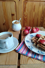 Belgian waffles with apples and honey on  wooden background. Homemade healthy breakfast. Selective focus