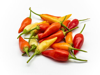 heap of colorful assorted chili peppers on a white background