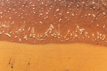 Soft wave of the sea on the sandy beach.