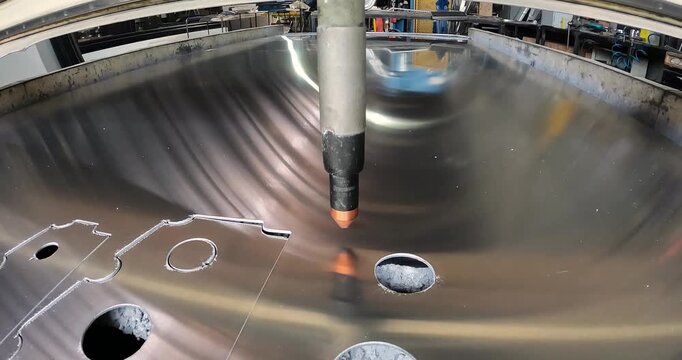 The process of cutting a metal part with a plasma cutter. Plasma cutting. Plasma cutter work at the factory. The plasma cutter will cut the part.