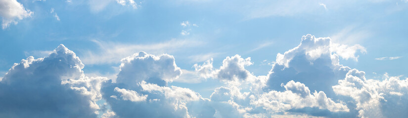 White curly clouds illuminated by the bright sun