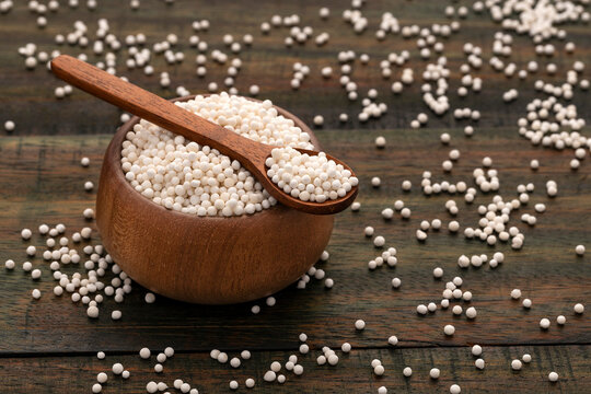 Starch tapioca pearls in the bowl and spoon - Manihot esculenta.