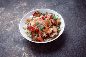 Salad panzanella of tomatoes and paper with fresh greens. Fresh vegetable mix at dark table. Top view, Copy space.
