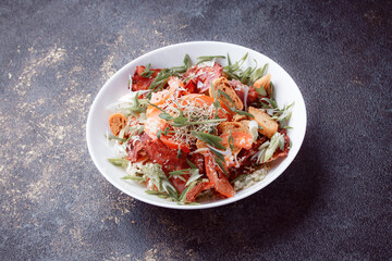 Salad panzanella of tomatoes and paper with fresh greens. Fresh vegetable mix at dark table. Top view, Copy space.