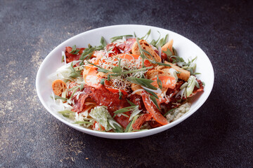 Salad panzanella of tomatoes and paper with fresh greens. Fresh vegetable mix at dark table. Top view, Copy space.