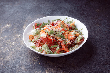 Salad panzanella of tomatoes and paper with fresh greens. Fresh vegetable mix at dark table. Top view, Copy space.