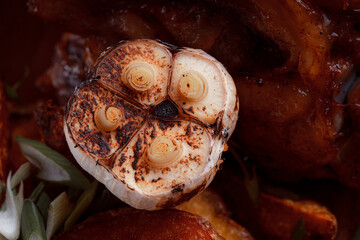 A set dish: a large fried piece of meat on the bone, country-style grilled potatoes, a mini salad of cabbage, bean sprouts, chia seeds and green onions. Original serving on a wooden cutting board.