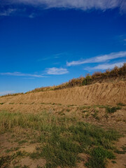 Sand in a quarry. White sand of a quarry, Clay, beautiful sand, sand mining in a quarry.Quarry against the background of a blue clear sky