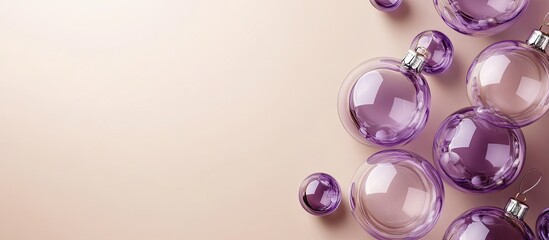 Fototapeta premium Numerous purple transparent glass Christmas decoration baubles on a beige background Copy space close up