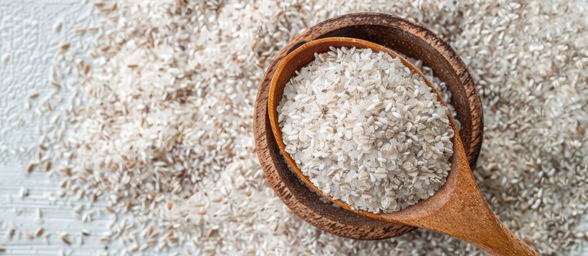 Psyllium husk in a bowl with a spoon on a white background. with copy space image. Place for adding text or design
