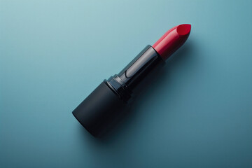 red lipstick close-up in elegant black case lies on blue background