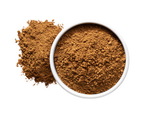 cinnamon powder spilled out of a ceramic bowl isolated on a white background, top view.