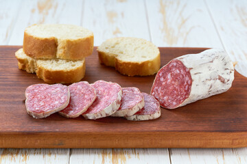 Sliced salami sausage on wooden table , selective focus.