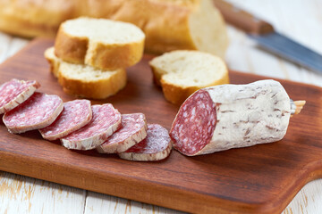 Sliced salami sausage on wooden table , selective focus.