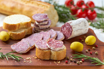 Fermented salami with fennel seeds, Italian traditional sausage, with colorful peppercorns.