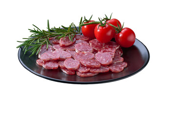fuet sausage cut in slices on a black plate with peppercorns and fresh rosemary, isolated on a white background.