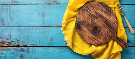 Wooden board and napkin on a colored background. with copy space image. Place for adding text or design