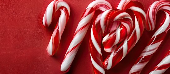 Border of small red and white striped candy canes in heart shapes. with copy space image. Place for adding text or design