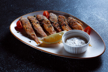 King fish on a large white dish. Fish fried in batter with a beautiful presentation. Cooked seafood...