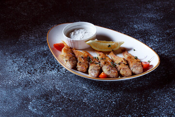 King fish on a large white dish. Fish fried in batter with a beautiful presentation. Cooked seafood...