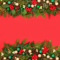 Christmas winter holly berry, mistletoe, ivy, cedar fir, pine cone and glitter bauble decoration on red background border. Nature flora greenery festive design for holiday season.
