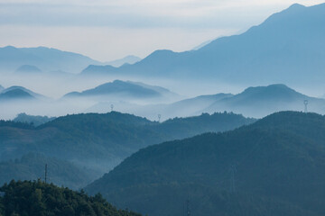 view of green mountains in fog