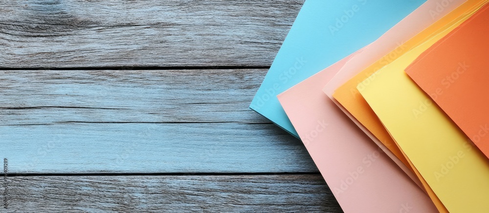 Poster Colored paper on a wooden background. with copy space image. Place for adding text or design